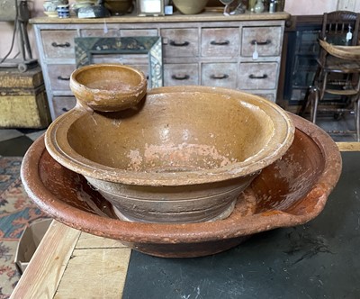 Lot A small terracotta pancheon with an attached strainer.