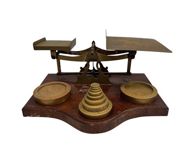 Lot 200 - A set of oak and brass postal scales with...