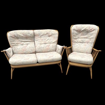 Lot 34 - An Ercol two-seat sofa and chair; the chair...