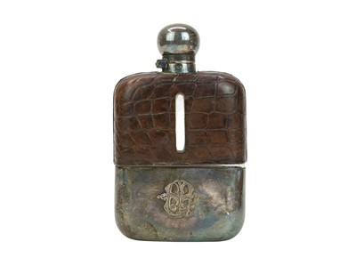 Lot 145 - A late 19th/early 20th century crocodile effect leather covered glass hip flask.