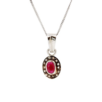 Lot 53 - A silver, ruby, and diamond cluster pendant necklace.