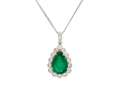 Lot 90 - An 18k two-tone gold, emerald, and diamond pendant on a silver necklace.