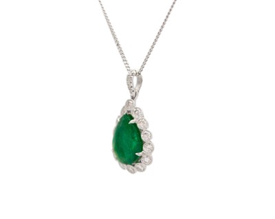 Lot 90 - An 18k two-tone gold, emerald, and diamond pendant on a silver necklace.