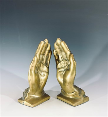 Lot 301 - A pair of brass bookends cast as praying hands,...