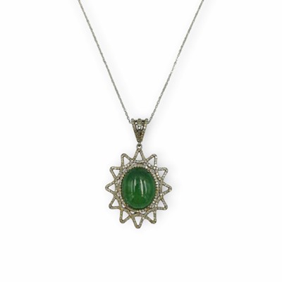 Lot 164 - A silver, green tourmaline, and diamond sunburst pendant on a silver chain.