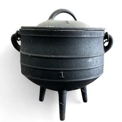 Lot 9 - A one gallon cast-iron camping cauldron and...
