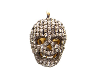 Lot 57 - A gold-plated silver and diamond skull-shaped pendant.