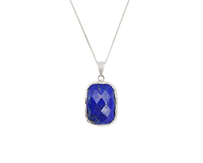 Lot 121 - A silver and lapis lazuli pendant on a silver chain.