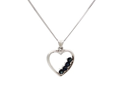 Lot 42 - A silver and sapphire heart-shaped pendant on a silver chain.