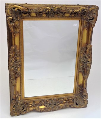 Lot 3511 - An ornate gilt framed rectangular wall mirror,...