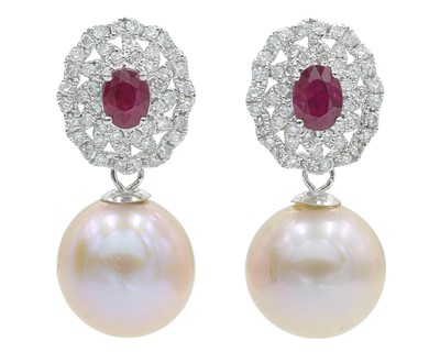 Lot 99 - A good pair of 18k white gold, cultured blush pink pearl, ruby, and diamond pendant stud earrings.