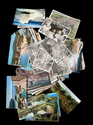Lot 134 - A box containing dozens of vintage postcards.