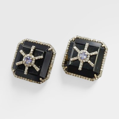 Lot 168 - A pair of square-shaped silver, black onyx, tanzanite, and diamond stud earrings.