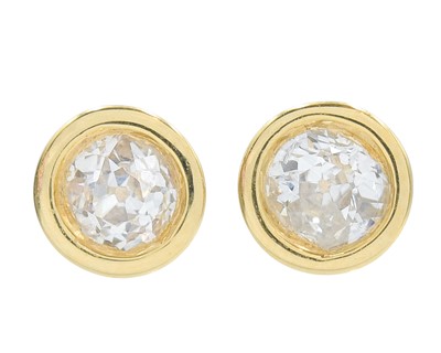 Lot 103 - A pair of 18k gold diamond solitaire stud earrings.