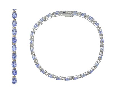 Lot 107 - An 18k white gold, tanzanite, and diamond line bracelet.