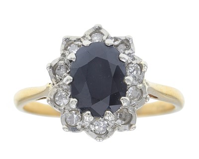 Lot 74 - An 18k gold, teal sapphire, and diamond cluster ring.