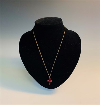 Lot 2594 - A very high purity gold cross set six rubies...