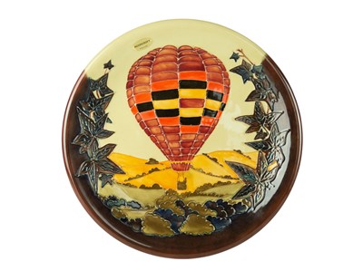Lot 439 - A large limited edition Moorcroft tube lined pottery charger with hot air balloon decoration.