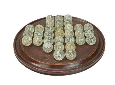 Lot 272 - A solitaire board with Mica marbles.