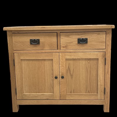 Lot 47 - A blonde oak sideboard with two drawers over a...