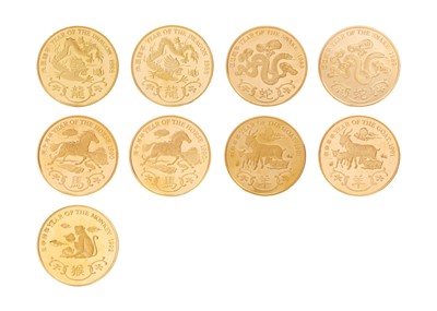 Lot 54 - HONG KONG LUNAR ANIMAL 22K GOLD MEDAL SET - A set of nine gold proof medals with booklets.