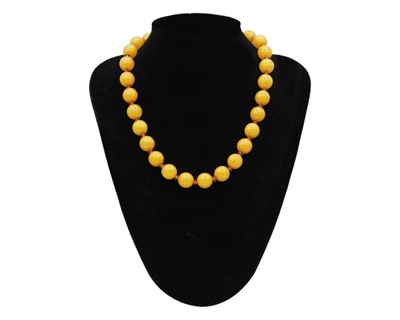 Lot 46 - An assortment of amber and amber-style bead necklaces.
