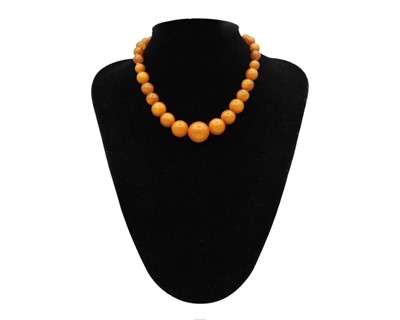 Lot 46 - An assortment of amber and amber-style bead necklaces.
