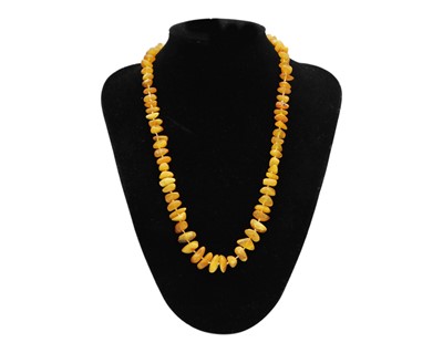 Lot 46 - An assortment of amber and amber-style bead necklaces.