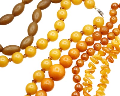 Lot 46 - An assortment of amber and amber-style bead necklaces.