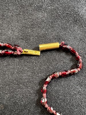 Lot 41 - A very fine garnet bead necklace, and two strings of garnets.