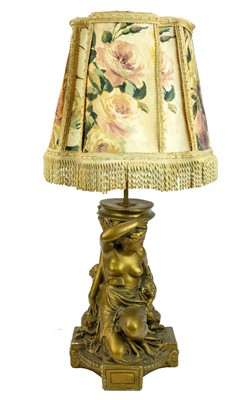 Lot 83 - A gilt and cream painted plaster table lamp.