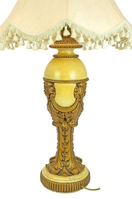 Lot 83 - A gilt and cream painted plaster table lamp.