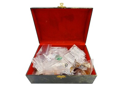 Lot 26 - An assortment of loose gemstones in a box.