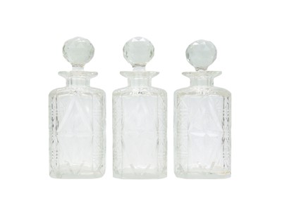 Lot 431 - A set of three Edwardian cut glass decanters and stoppers.