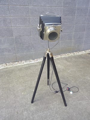 Lot 161 - A tripod lamp fashioned as a plate camera. The...