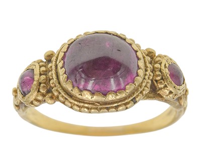Lot 155 - An Antique Etruscan style granulated gold three-stone pink sapphire and tourmaline set ring.