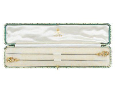 Lot 150 - An Edwardian pair of 9k gold and turquoise hat pins by J.C.Vickery, within original box.