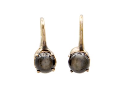 Lot 161 - A pair of 18k gold, black star sapphire screw-back earrings.