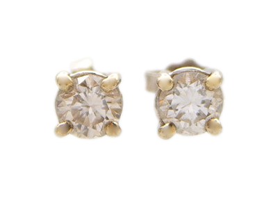 Lot 165 - A pair of 18k white gold and 0.50ct diamond solitaire stud earrings.