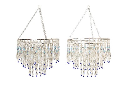 Lot 834 - A pair of blue beaded three tier glass chandeliers.