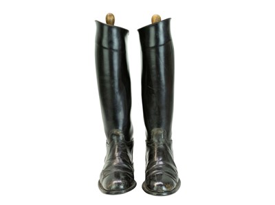 Lot 31 - A pair of black leather riding boots and trees.
