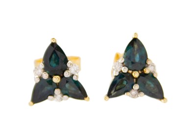 Lot 171 - A pair of 9k gold, teal sapphire, and diamond stud earrings.