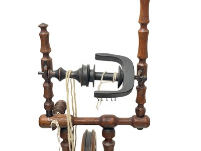 Lot 35 - An oak and elm spinning wheel.