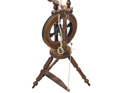 Lot 35 - An oak and elm spinning wheel.