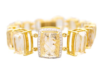 Lot 174 - An attractive 18k gold and rutilated quartz articulated bracelet.
