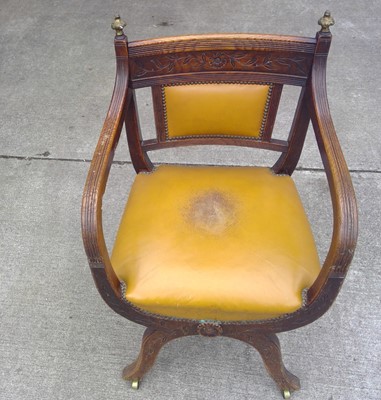 Lot 37 - A Low Back Oak Desk Chair on castors. The...