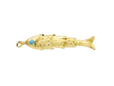 Lot 69 - A high-purity gold (tests 18k) articulated fish pendant with turquoise set eyes.