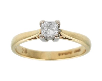 Lot 70 - An 18k diamond solitaire ring.