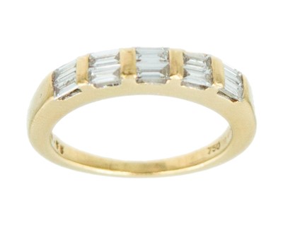 Lot 105 - An 18k yellow gold 0.55ct baguette diamond ten-stone ring.