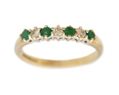 Lot 108 - A 9k diamond and emerald six-stone ring.